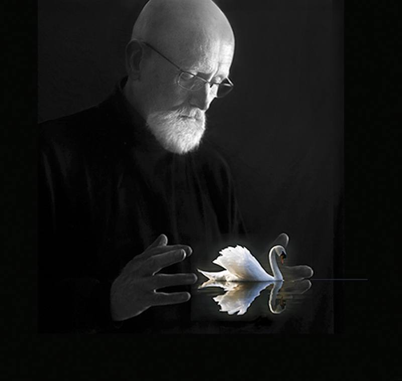 Rick Conroy holding his hands at chest level with a swan floating on the water photoshopped in between his hands